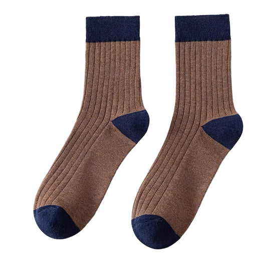 Pair of brown socks with navy accents on a white background